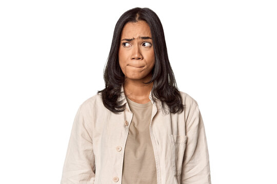 Portrait of a young Filipino woman confused, feels doubtful and unsure.