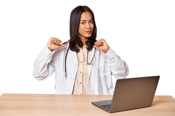 Young Filipino doctor with laptop in studio feels proud and self confident, example to follow.