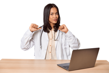 Young Filipino doctor with laptop in studio feels proud and self confident, example to follow.