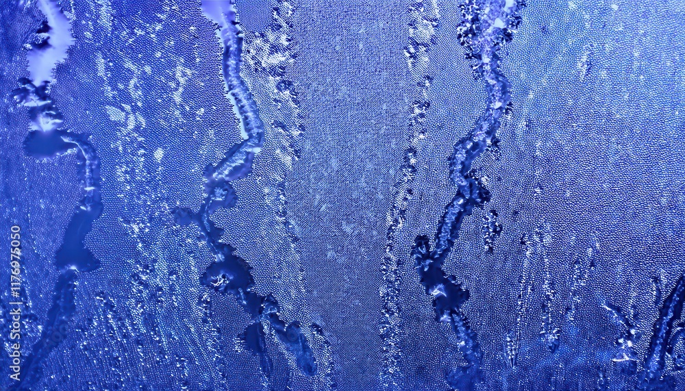Poster macro view of frost patterns on glass with feathery crystals and dew drops, capturing nature’s froze