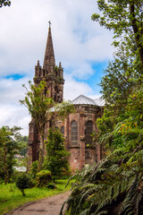 The Chapel of Nossa Senhora das Vitórias on a Furnas lake with foliage, Furnas, on the Azorean island of São Miguel. Neo-Gothic architecture. Small funerary chapel