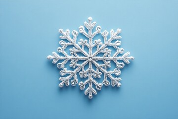 Decorative white snowflake design against a vibrant blue background