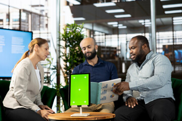 Startup CEO attends meeting to talk about new business vision with executive board member, using isolated screen tablet. Men using mockup device to pitch investment strategy to manager