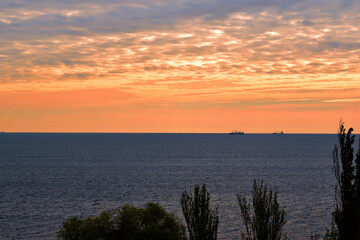 Sunset over the sea. horizon sea clouds in the sky. a boat in the distance, a beautiful color of...