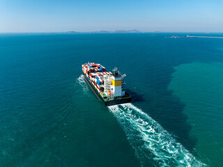 container ship sailing full speed with beautiful wave pattern line, cargo logistic and...