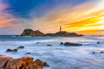 Beautiful Sunset Ke Ga Lighthouse with surf patted smoother reefs create clouds on sea as this is...
