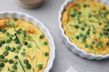 Mini Omelette Frittatas with Peas and Zucchini in White Ramekins