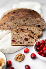 Sliced Artisan Cranberry and Walnut Sourdough Bread on a Rustic Setting