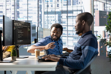 Manager in wheelchair checks on employee testing machine learning company software to minimize...