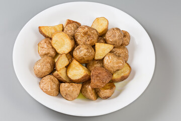 Pieces of potato baked in their skins in rustic style
