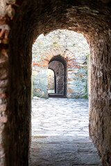 Fototapeta premium Medieval doorway and passes on the old stone wall. Old fortress tunnel from 15th century. The Smederevo Fortress, a medieval fortified city in Smederevo, Serbia