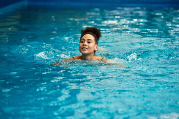 Relaxing moments in a tranquil spa pool with a joyful young woman enjoying leisure time