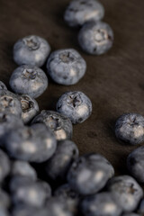 a pile of blueberries scattered on the board