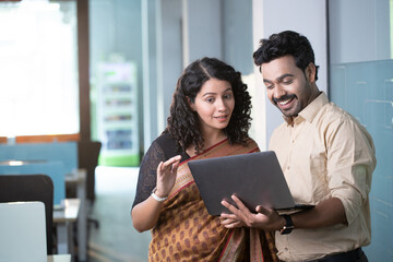 Two People Discussing Something Over Laptop