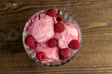 delicious sweet cold raspberry-flavored ice cream and ripe raspberries in a glass