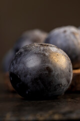 close-up of purple plum fruits in drops of water