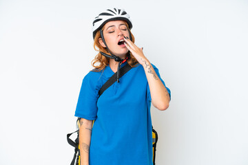 Young caucasian woman with thermal backpack isolated on white background yawning and covering wide open mouth with hand