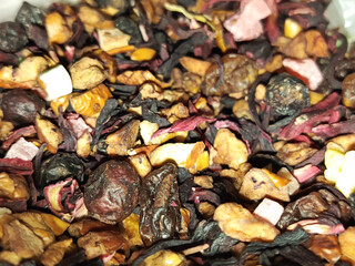Dry tea with dried fruits close-up. Dried rosehip berries for tea. Dry fruits for hot drinks. 