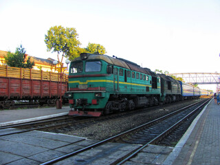 Naklejka premium A vintage locomotive at a rural train station