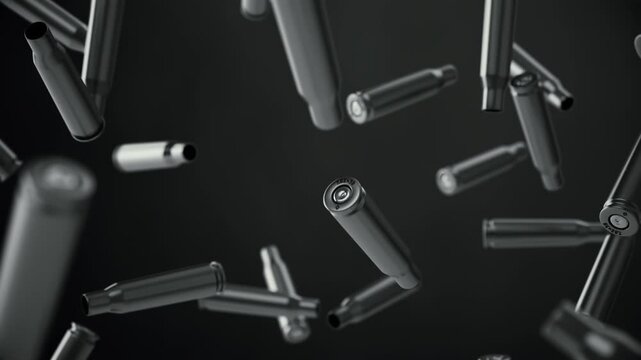 Falling spent cartridges from automatic weapons on a dark background. Looping animation