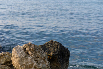 Serene waterside view with beautiful rocky formations at dawn's gentle light