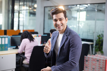 Sales Director Making Thumb Up Gesture At Camera