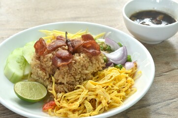 fried rice mixed with shrimp paste eat couple egg and vegetable on plate