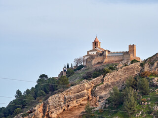 Obraz premium Iznajar village. Mountain village surrounded by the Iznajar Reservoir. Parish of Santiago Apostol. Iznajar Castle