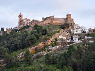 Obraz premium Iznajar village. Mountain village surrounded by the Iznajar Reservoir. Parish of Santiago Apostol. Iznajar Castle