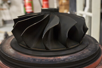 Close up of a Turbocharger turbine wheel, with blades covered in carbon soot deposits.