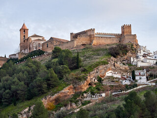 Fototapeta premium Iznajar village. Mountain village surrounded by the Iznajar Reservoir. Parish of Santiago Apostol. Iznajar Castle