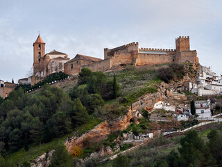 Fototapeta premium Iznajar village. Mountain village surrounded by the Iznajar Reservoir. Parish of Santiago Apostol. Iznajar Castle
