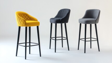 Three stylish bar stools in yellow, gray, and dark gray upholstery with black legs.