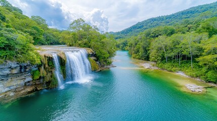 Fototapeta premium The Erawan waterfall cascades down seven tiers of lush greenery, surrounded by towering trees and vibrant flora in the heart of the Kanchanaburi jungle