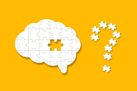 A missing piece of the brain puzzle on yellow background. A question mark design made of puzzle pieces. 