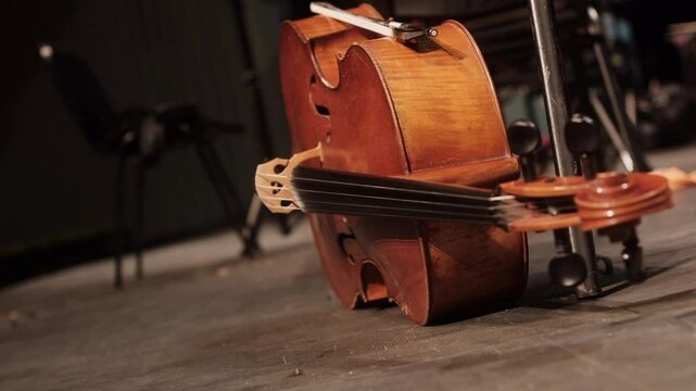 Vintage cello lying on the stage floor