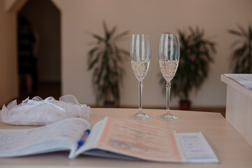 Elegant Celebration Setting with Champagne Glasses and Wedding Documents