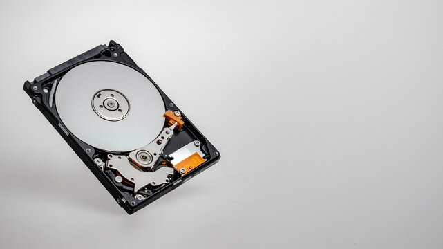 a computer's hard disk hdd data storage drive without shield isolated  in white background show magnetic disc and electronic part inside