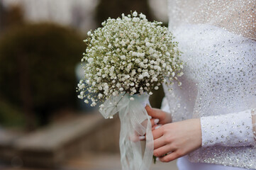 Elegant Bride Holding a Delicate Baby's Breath Bouquet