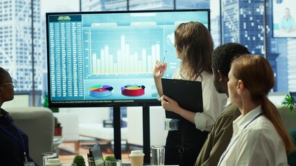The CEO and management team gathering in boardroom for a project briefing, focusing on enterprise...