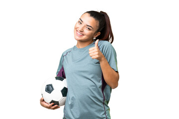 Young football player Woman over isolated chroma key background giving a thumbs up gesture © luismolinero