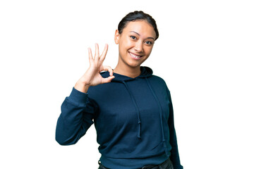 Young Uruguayan woman over isolated chroma key background showing ok sign with fingers