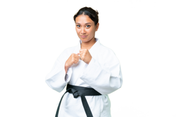 Young Uruguayan woman over isolated chroma key background doing karate