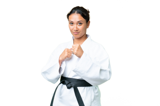Young Uruguayan woman over isolated chroma key background doing karate
