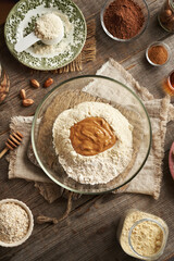 Whey protein powder, ground oat flakes, nut butter, cinnamon and raw cacao - ingredients for homemade protein chocolate bars