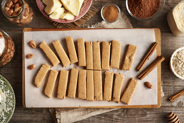 Homemade bars made of whey protein powder, ground oat flakes, maple syrup, cinnamon and nut butter, top view