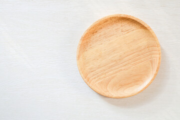Wooden plate on white background