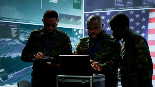 Military officer in a high tech control center engages in cybersecurity operations, protecting classified data from threats and managing digital warfare strategies to maintain state secrets. Camera A.