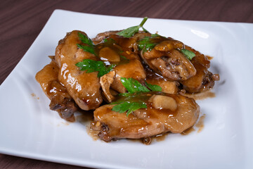 Cola chicken wings on a white plate