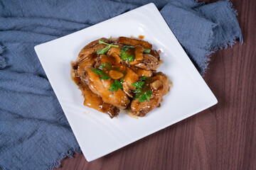 Cola chicken wings on a white plate